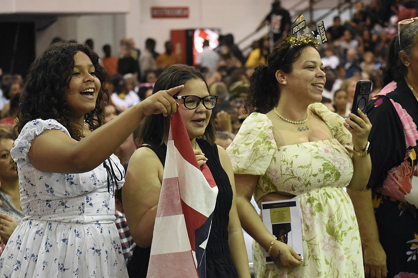 Marley Martinez, 11, Yalexes Martinez, 13 and Yani Reyes watch as Angel Martinez takes to the stage.