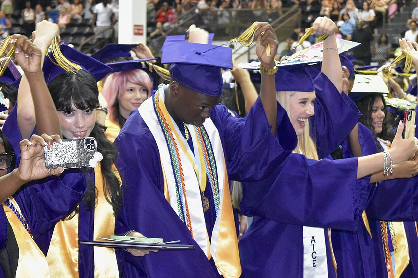 Giselle Martin Del Campo-Gonzalez, Isaiah Pinckney and Kila Sons turn their tassels.