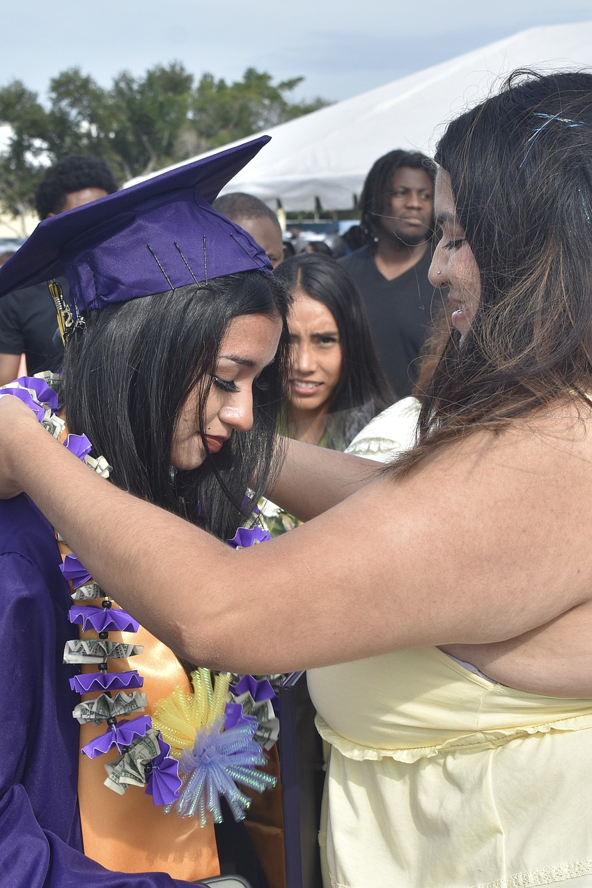 Allison Morales receives a lei from her sister Ashley Morales.