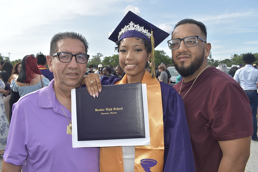 Silviana Mendoza (center) celebrates with her grandfather Juan Mendoza and father Juan Mendoza Jr.