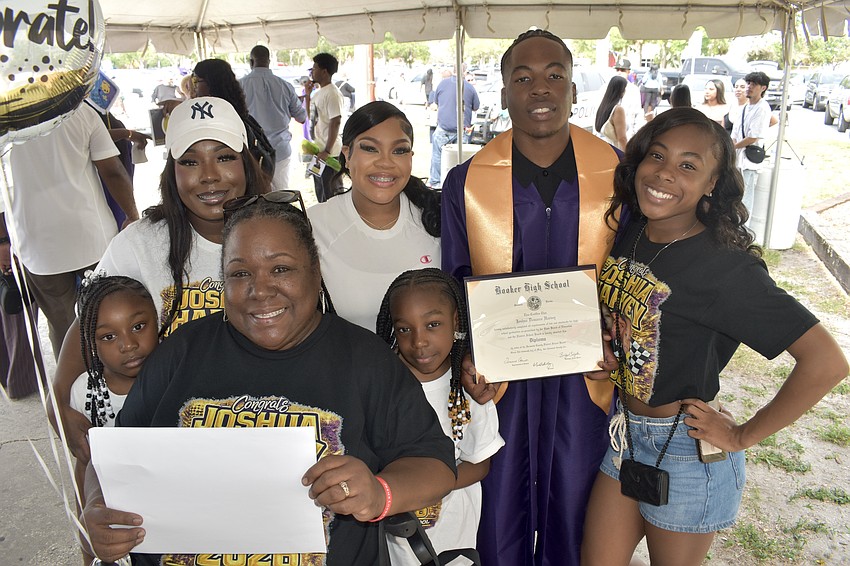 Joshua Harvey (first from right) celebrates with his family including sisters Faith Harvey and Alaija Pitts, grandmother Jennifer Harvey, mom Whitney Harvey and sisters Joy Harvey and Ariana Harvey.