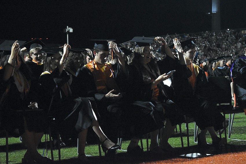 Students move their tassels.