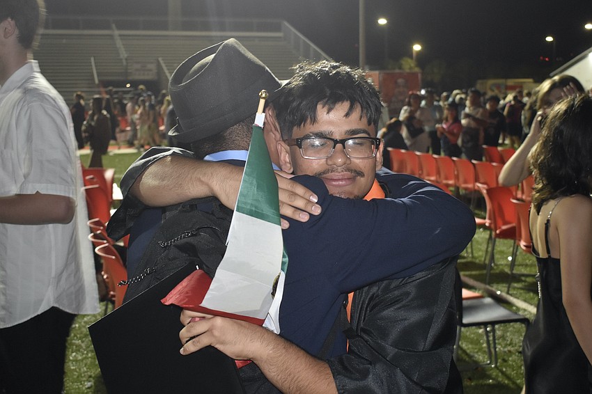 Roy Rivera hugs Hamilton Mendoza.