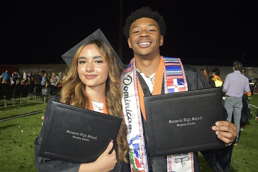 Anna Sofia and Daniel Sanchez show their diplomas.