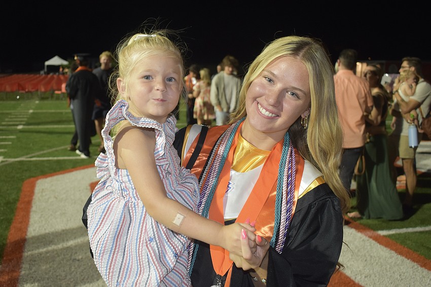 Chloe Rebholz, 3, celebrates with her sister, graduate Braelynn Rebholz.