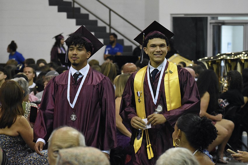 Joshua Coelho and Cesar Cisneros head to their seats.