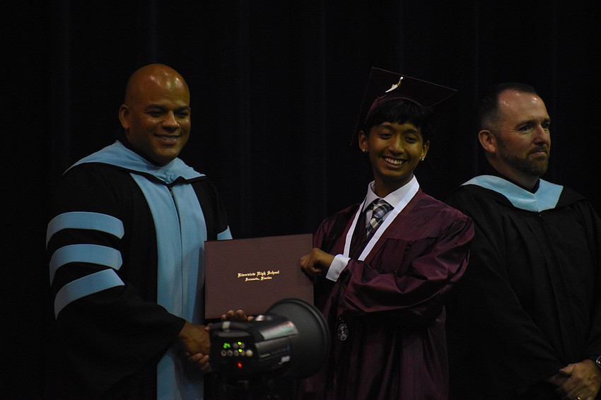 Nate Francis, executive director of secondary schools, greets Jesus Morales-Magana.
