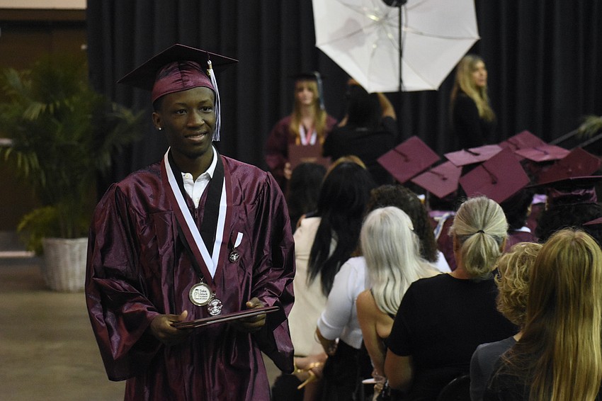Anthony Shuler leaves the stage with a diploma.