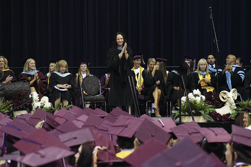 Principal Erin Haughey applauds the graduates.