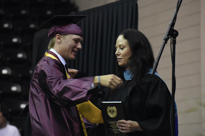 Aaron Nielsen receives the Principal's Award from Principal Erin Haughey