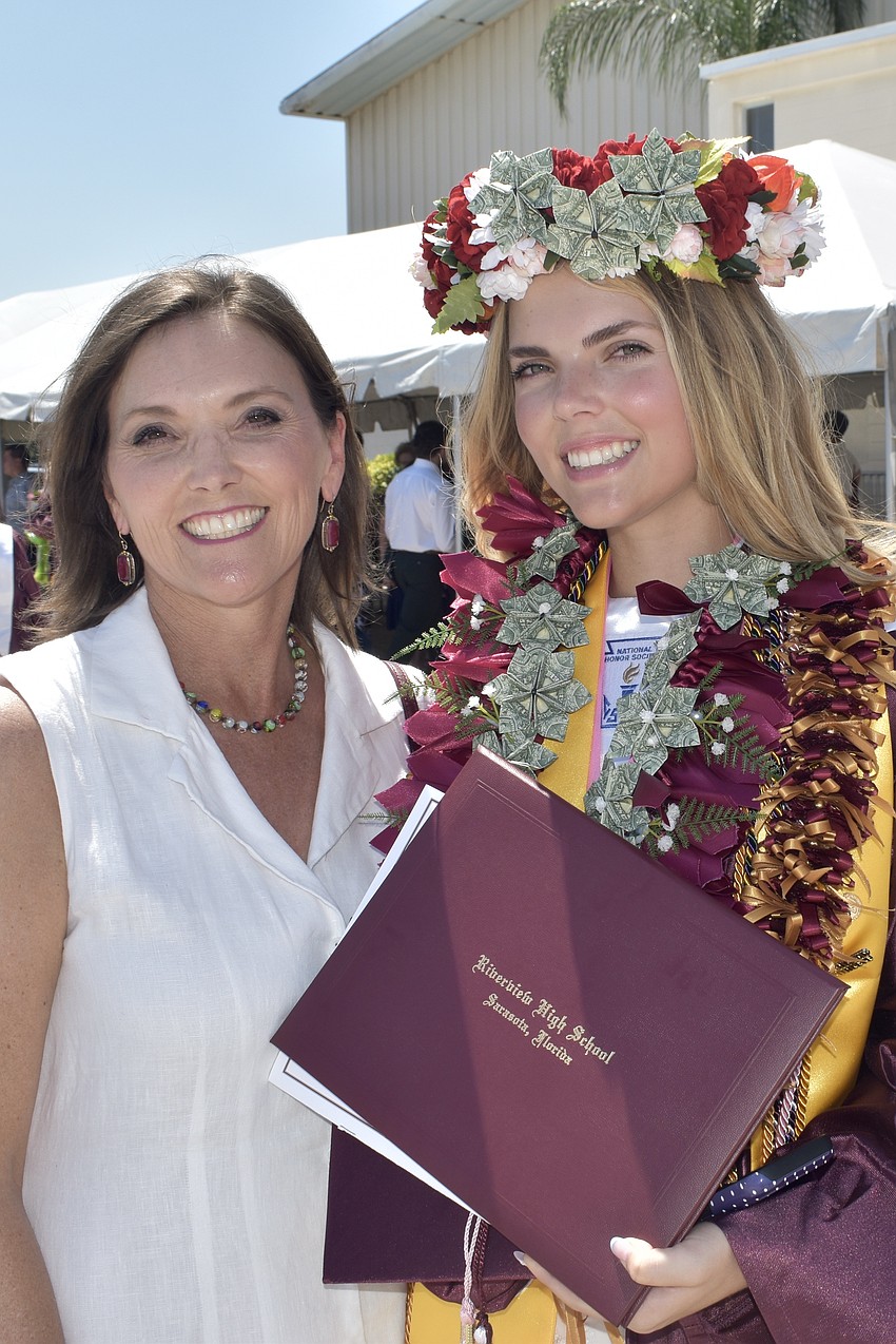 Jennifer Siddons and her daughter Kathleen Siddons celebrate graduation, with Kathleen wearing a flower lei.