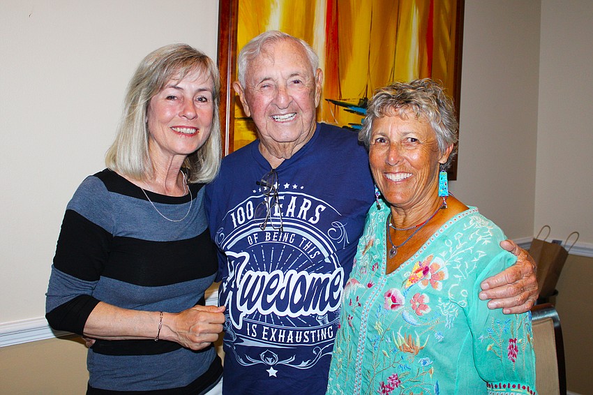 Longboat Key Tennis Center manager Kay Thayer celebrates with Harold and Beth Goldstein.