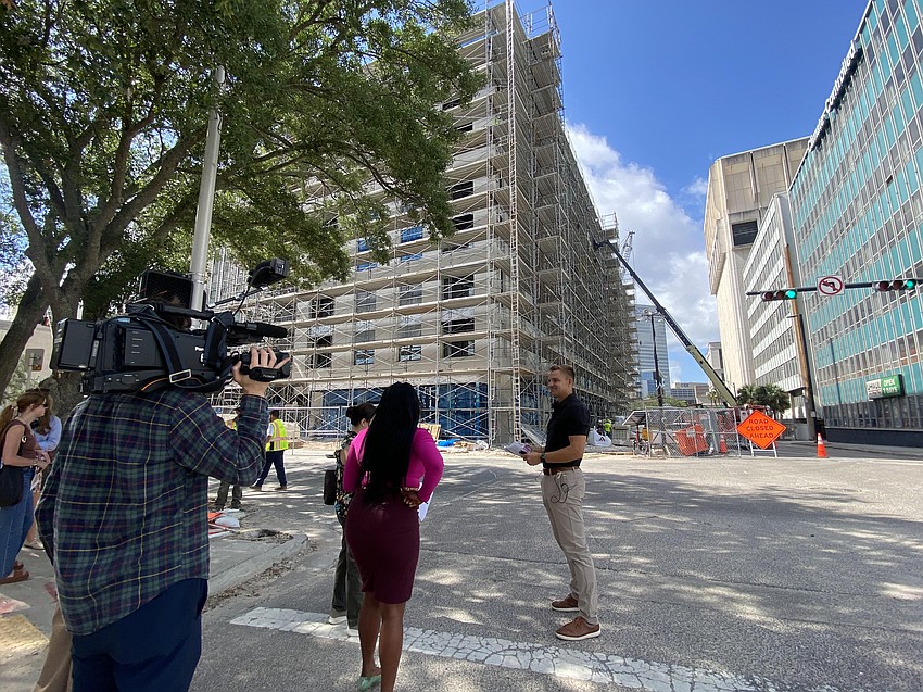 Bryan Moll, CEO of Gateway Jax, answered questions May 19 during a media tour of the Pearl Square district in Downtown Jacksonville. In the background is Gateway’s Vandeveer apartments and retail buildng at 515 N. Pearl St. Moll said Gateway plans to begin leasing the living units in late summer and is expecting to make an announcement soon on retailers and restaurants in the building.