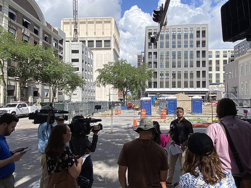 During a May 19 media tour of the Pearl Square district in Downtown Jacksonville, Gateway Jax CEO Bryan Moll fielded questions about the projects behind him in this photo: The Vandeveer apartments and retail building, at right, and Hotel Merrydelle, at left. A parking garage is under construction adjacent to the hotel, previously the Ambassador Hotel.