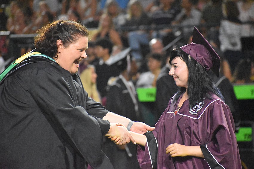 Rebecca Austerman, an assistant principal at Braden River High School, congratulates graduating senior Jordan Tucker.