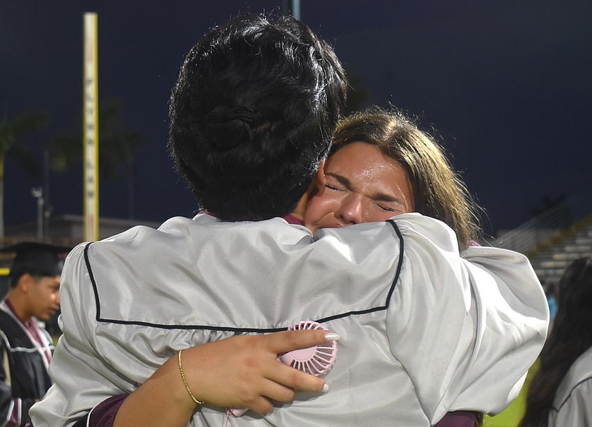 As Madison Ogline receives a hug from Aaden Kien, she feels pure shock they made it through the ups and downs of high school.