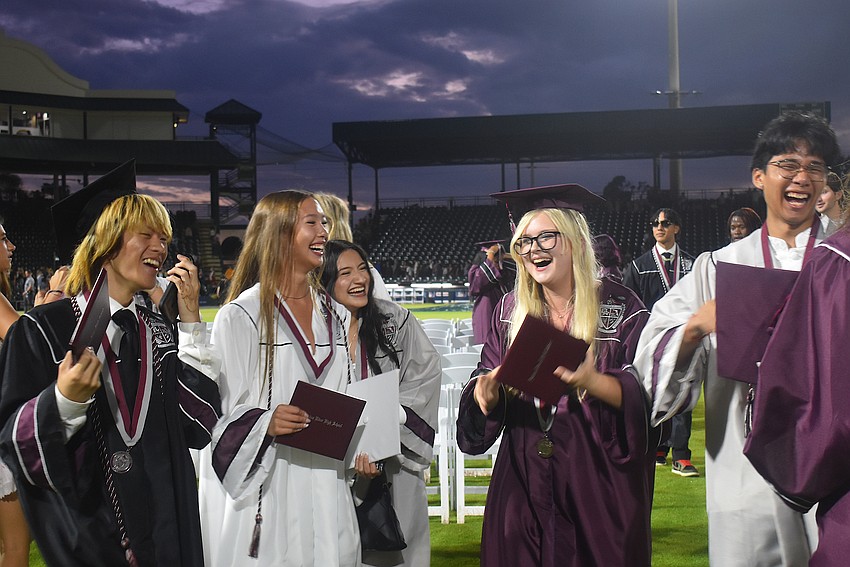 Braden Nguyen, Leah Vo, Lily Medina, Emma Sturtevant and Aaden Kien celebrate their accomplishment after the ceremony ended May 19.