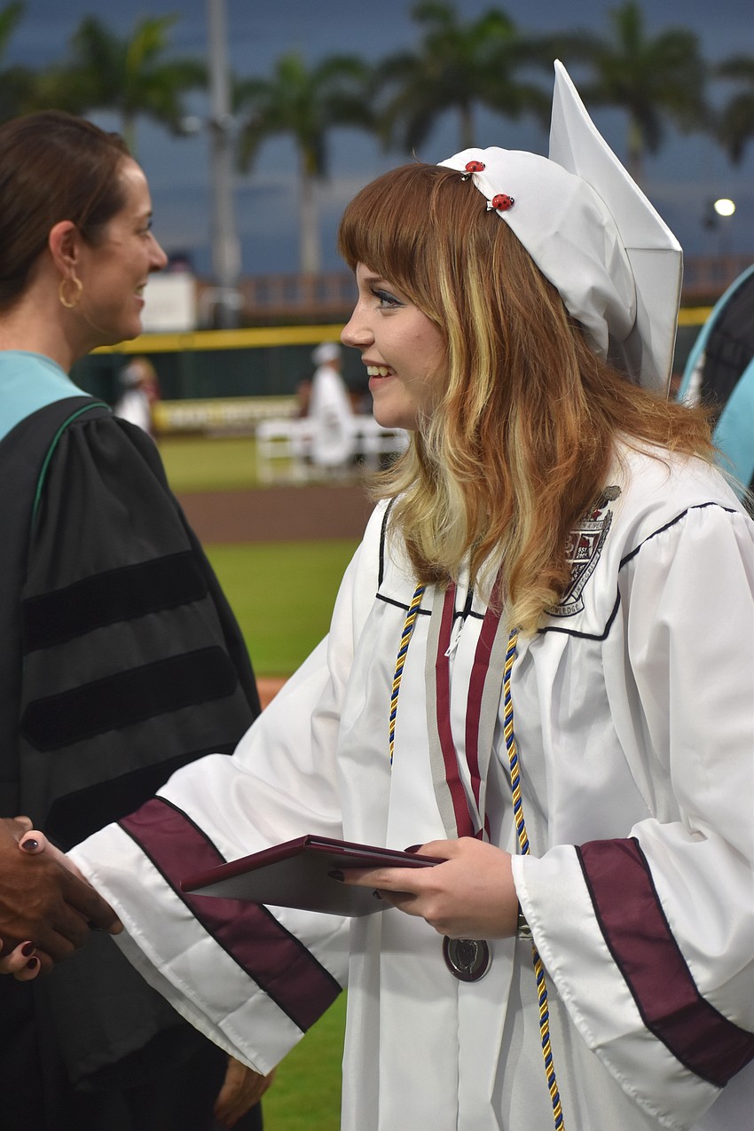 Alexis Huffstutler, who has been part of the Braden River theater department for the past three years, makes her way down the line with her diploma in hand.