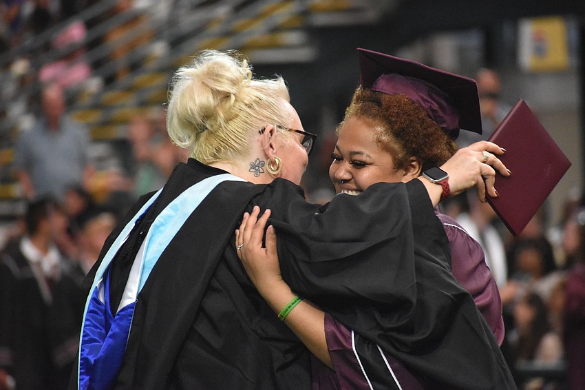 Laura Gonzales, an assistant principal at Braden River High, gives graduate Ahaunestee Heard a congratulatory hug.