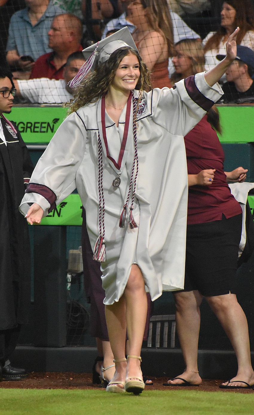 Ava Losada, a member of the Black Pearls dance team at Braden River, waves as her name is called.