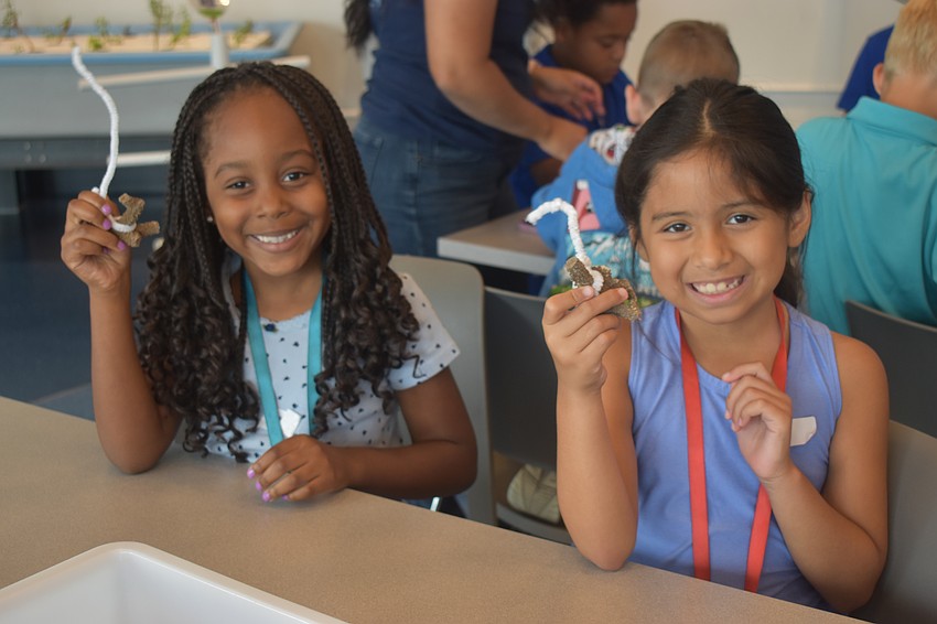 Lake Manatee first graders Alexis Cotton and Briella Quilambaqui learn in the Marine Ecology Lab at Mote Sea on May 11.
