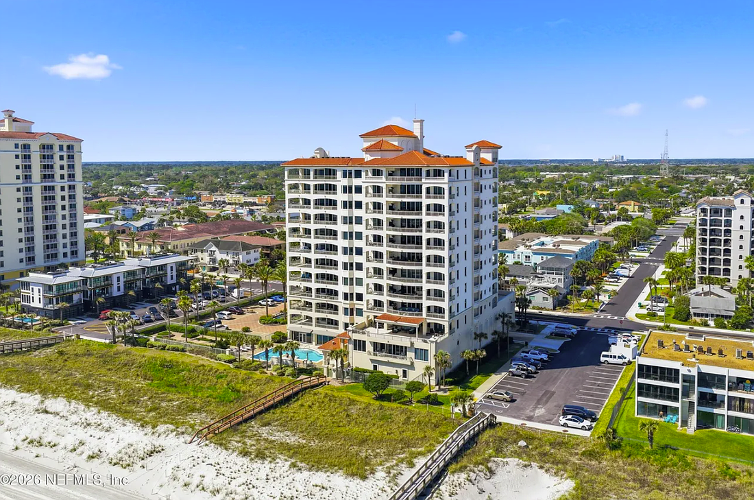 Oceanfront penthouse features four bedrooms, four full and one half-bathrooms, an office, balconies, an outdoor kitchen, a spa and two garage spaces.