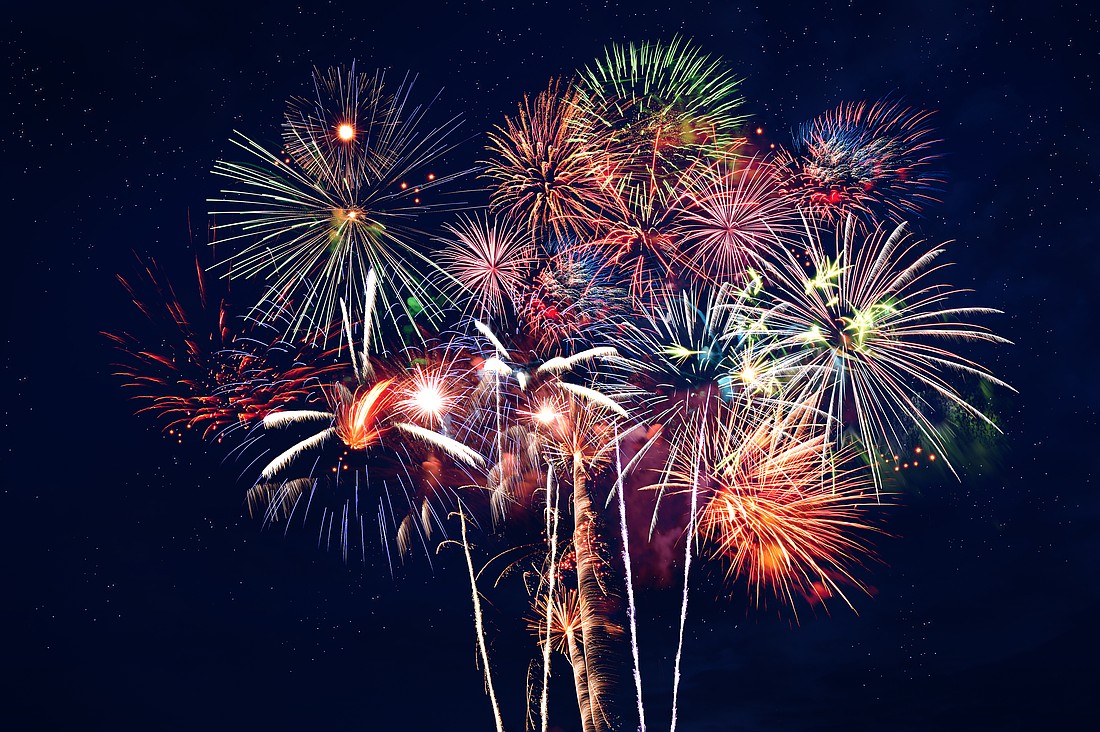 Fireworks at night over dark blue sky. Adobe Stock image