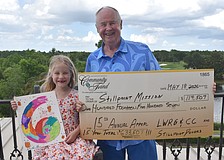Ellie Tullidge, 6, is glad to help her grandfather Bob Smith celebrate raising another $114,507 for Stillpoint Mission this year, which makes the 15 year total $633,507.