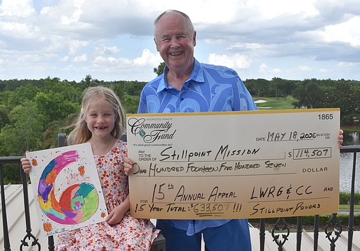 Ellie Tullidge, 6, is glad to help her grandfather Bob Smith celebrate raising another $114,507 for Stillpoint Mission this year, which makes the 15 year total $633,507.
