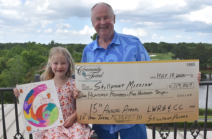 Ellie Tullidge, 6, is glad to help her grandfather Bob Smith celebrate raising another $114,507 for Stillpoint Mission this year, which makes the 15 year total $633,507.
