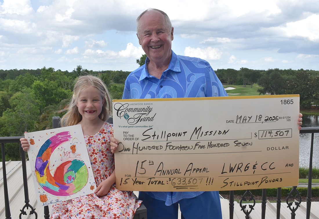 Ellie Tullidge, 6, is glad to help her grandfather Bob Smith celebrate raising another $114,507 for Stillpoint Mission this year, which makes the 15 year total $633,507.