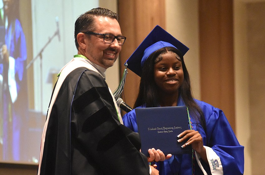 Head of School Chad McBane presents Senior Class President Ciara Charles her diploma at the Lakewood Ranch Preparatory Academy commencement ceremony May 20 at The Ora.
