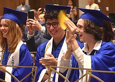 Molly Reichenbach, Caio Menegardo and Brian Scanlon cheer for their classmates as they receive their diplomas from Lakewood Ranch Preparatory Academy May 20.