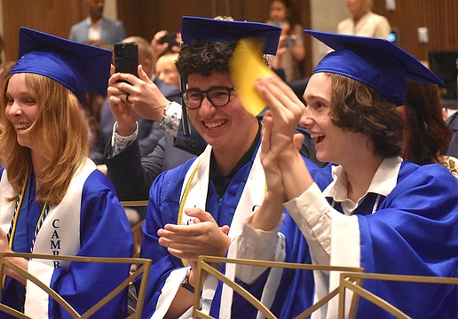 Molly Reichenbach, Caio Menegardo and Brian Scanlon cheer for their classmates as they receive their diplomas from Lakewood Ranch Preparatory Academy May 20.