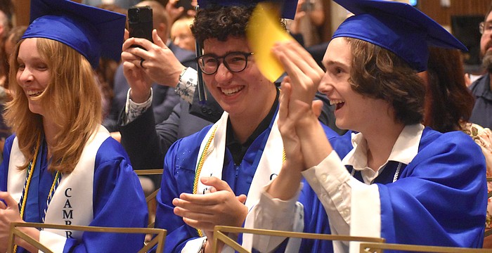 Molly Reichenbach, Caio Menegardo and Brian Scanlon cheer for their classmates as they receive their diplomas from Lakewood Ranch Preparatory Academy May 20.