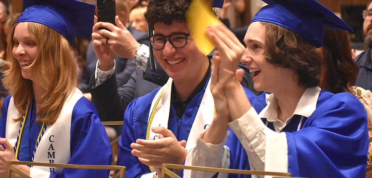 Molly Reichenbach, Caio Menegardo and Brian Scanlon cheer for their classmates as they receive their diplomas from Lakewood Ranch Preparatory Academy May 20.