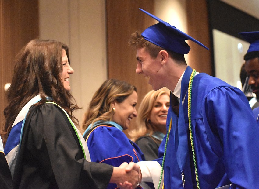 April Robinson, vice principal at Lakewood Ranch Preparatory Academy, congratulates graduate Braxton Molinaro May 20 at The Ora.
