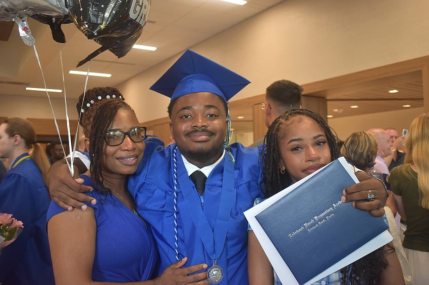 Alex Montrevil (center), his mom, Esther Pierre, and his sister, Alexya Montrevil, celebrate Alex's graduation.