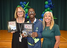 School safety patrol supervisor Justine Holcomb, Noah Moise and Principal Patti Folino stand together.