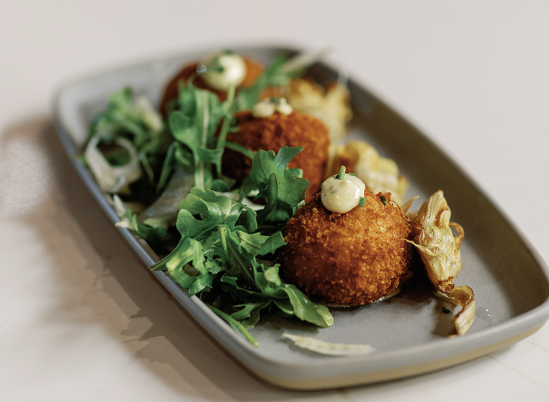 In addition to an extensive array of beverages, Vybe offers chef-driven creations like Gouda arancini with herb aioli and fennel arugula.