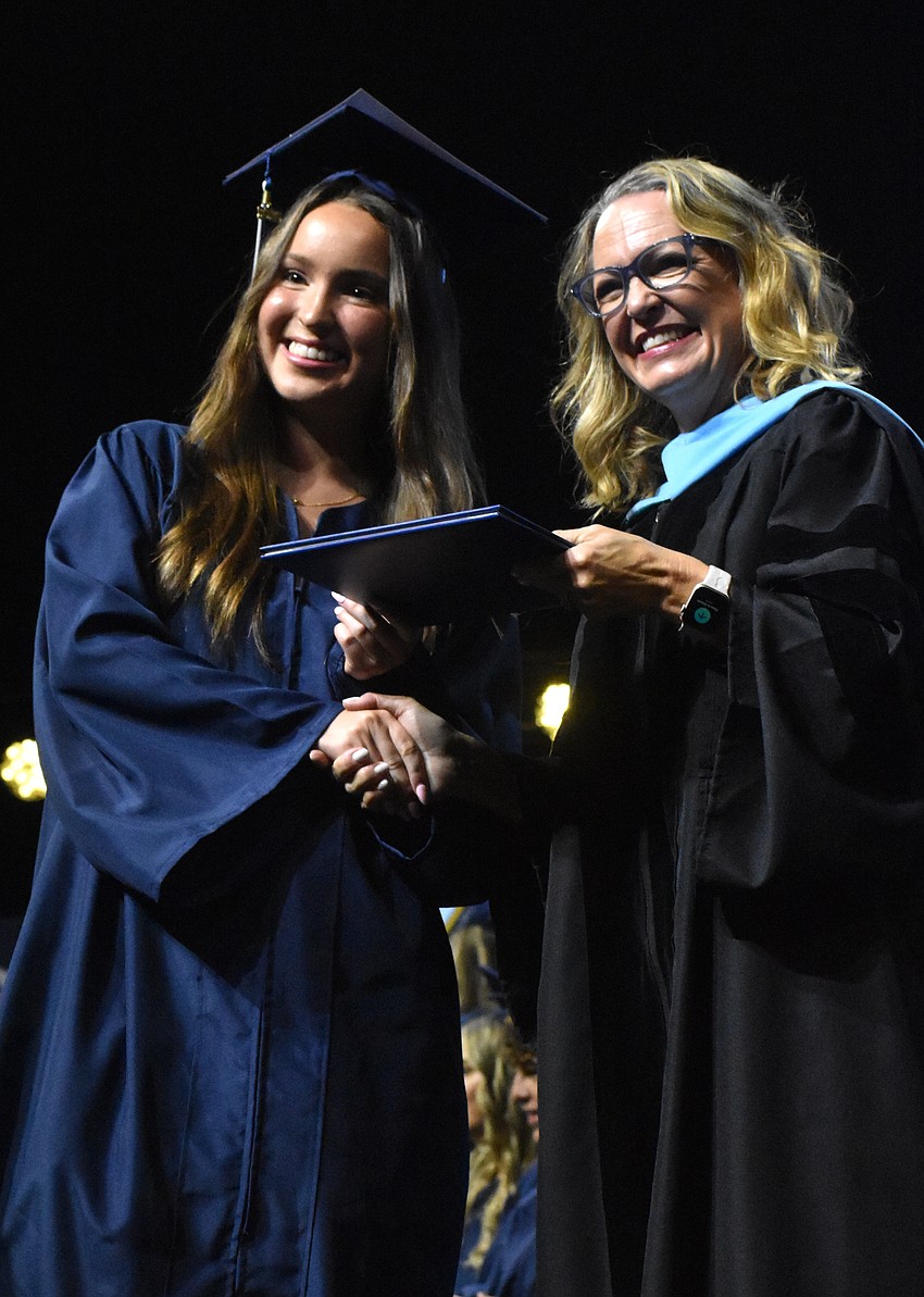 ODA graduate Grace Jeanes shakes hands with Debra Otey, head of school, as she receives her diploma May 22.