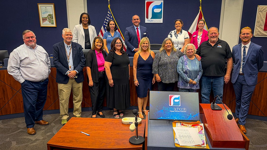 Flagler Schools' new retirees in attendance for the spotlight at the May 19 Flagler County School Board meeting, from left: Chief Human Resources Officer Bob Ouellette; Chief of Operations Dave Freeman; Flagler Auditorium Director Amelia Fulmer; Nancy Allesee, teacher for 39 years at Old Kings Elementary School; Rima Apanavicius, Belle Terre Elementary School; Beverly Ford, Flagler Teach College; Margaritte Streck, FTC; and Scott Howell, BTES; with new HR chief Joshua Walker (right). Back row: Superintendent LaShakia Moore and board memebers Christy Chong, Will Furry, Janie Ruddy and Lauren Ramirez. Photo by Don Foley/Flagler Schools.