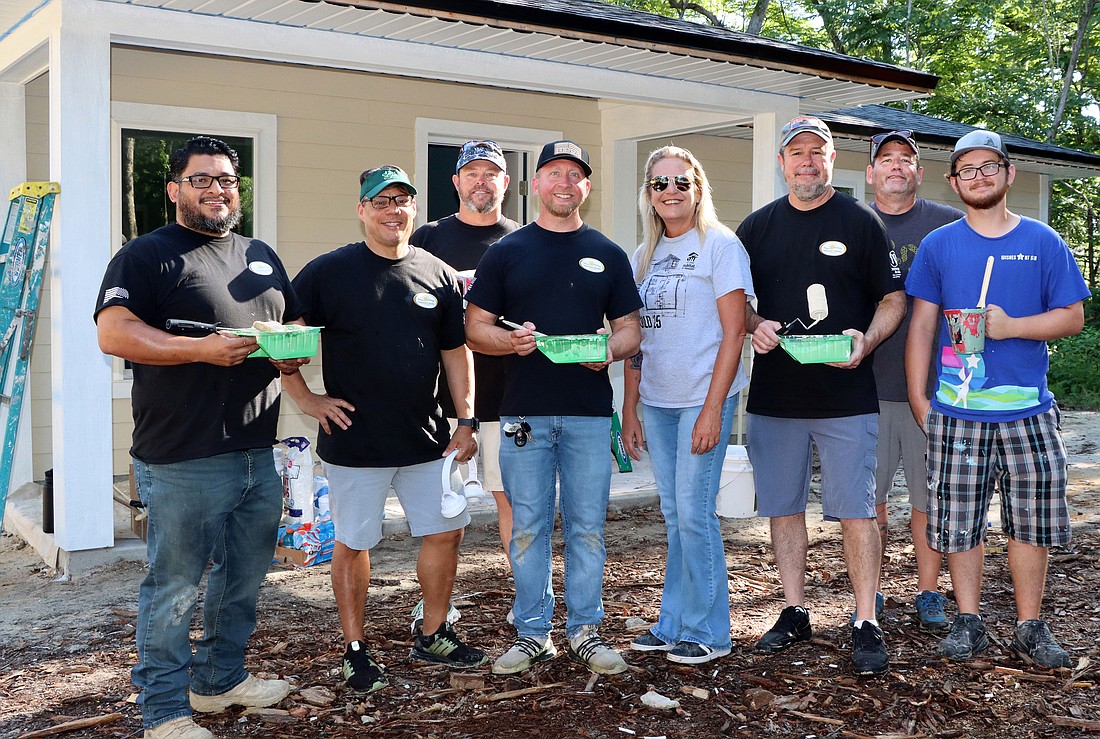 From left: Veterans Services Officers Juan Flores, Jose Da Silva and Shane Gross; Veterans Services Director Scott Olson; West Volusia Habitat for Humanity CEO Mandy Shrader; Veterans Services Officer Greg Burgess; and Corrections Officer Anthony Whited with his son, Ashton Whited. Courtesy photo