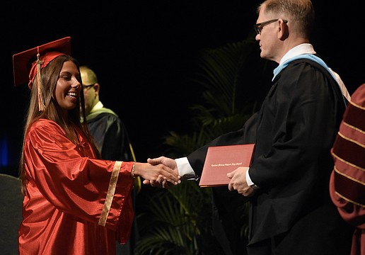 Emerson Lepper greets Principal Ben Hopper.
