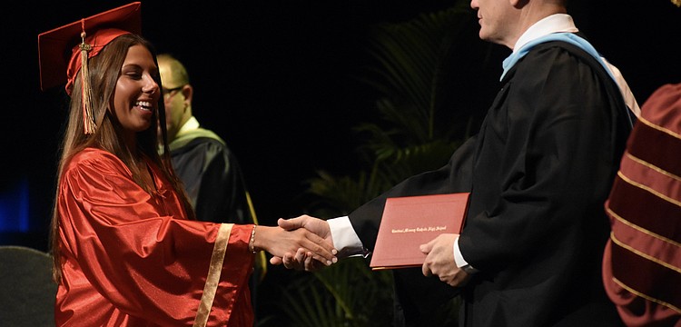Emerson Lepper greets Principal Ben Hopper.