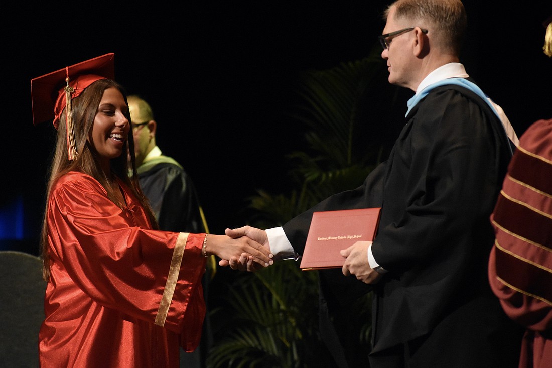 Emerson Lepper greets Principal Ben Hopper.