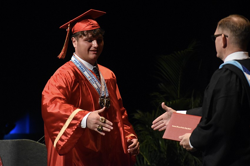Zackery Bernard Samuel greets Principal Ben Hopper.