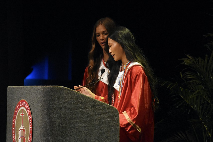 Senior Class Vice President Ava LaMorey and Senior Class President Esme Doan offer the Prayers of the Faithful.