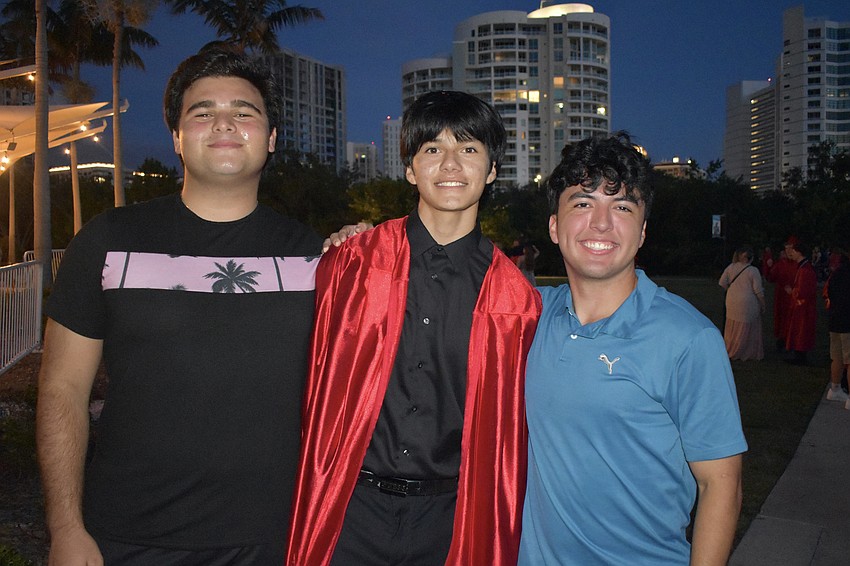 Michael Baio, graduate Maros Morales and Luigi Ferrari celebrate graduation.