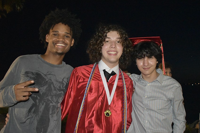 Jevon Walker, 17, and Jackson McCray and his brother Carter McCray, 16, celebrate together.